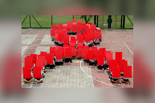 Singapūro studentai suformavo AIDS simbolį.